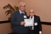 Dr. Nagib Callaos, General Chair, giving Dr. Bruce R. Barkstrom the best paper award certificate of the session "Information Systems, Technologies and Applications ." The title of the awarded paper is "Searching the Web for Earth Science Data: Semiotics to Cybernetics and Back."